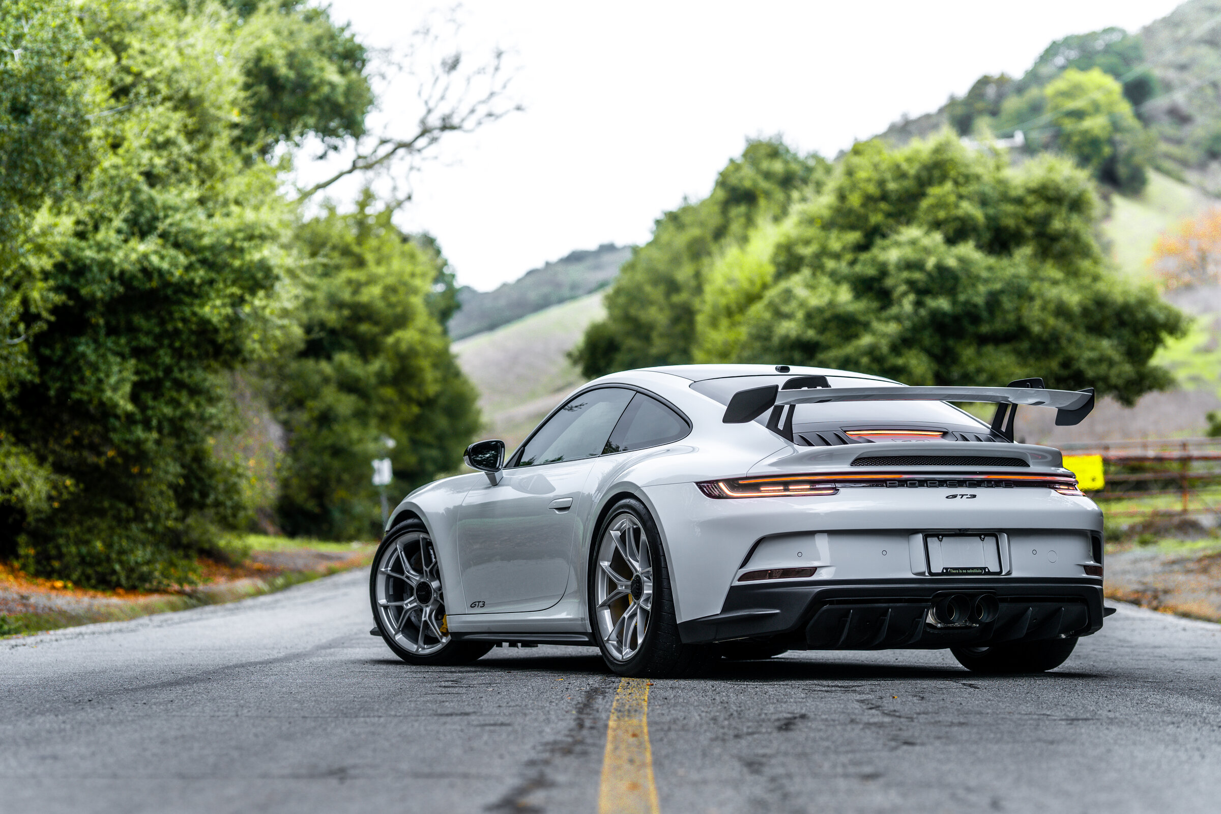 Porsche 911 GT3 rear wing on forest road